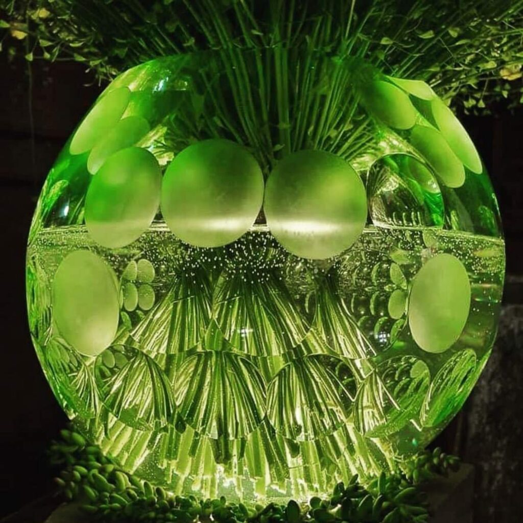 green glass crystal vase glowing green from backlight showcase handcrafted glass art