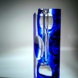 a faceted blue crystal sculpture art as a single flower bud vase or crystal decorative