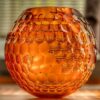 a large spherical orb amber glass piece for vase or table centrepiece made of artisan crystal amber glass entirely cut and polished by hand
